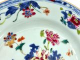 a blue and white plate with colorful flowers on it