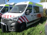 several ambulance vehicles parked in a grassy area with flowers in the foreground