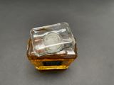 a small square glass container with a coin inside of it