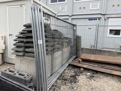 a fence that has a bunch of concrete blocks in it