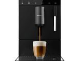 a black coffee machine with a cup of coffee in front of it
