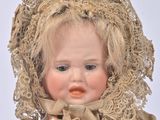 a doll that is wearing a bonnet and a dress