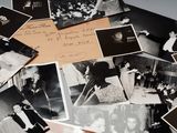 several old black and white photos of people and children on a table
