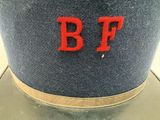 a blue hat with red letters on it sitting on a table