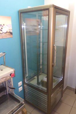 a glass display case in the corner of a room