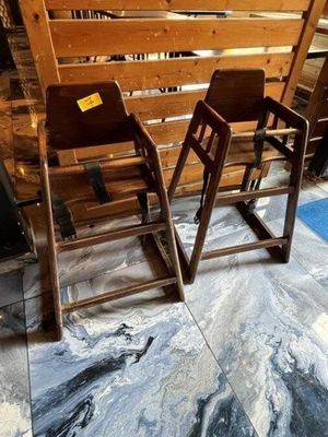 two wooden chairs sitting next to each other on the floor