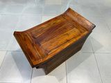 a wooden bench sitting on a tile floor in a room