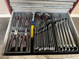 many tools in a tool box on the floor