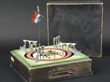 a miniature model of a ring with a flag on top