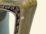 a vase with a handle that has a handle on it
