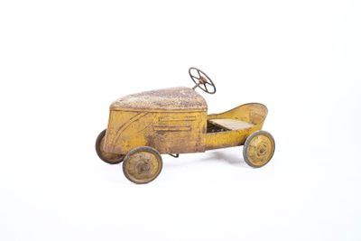 a small toy car with a steering on a white surface