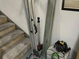 a picture of a room with stairs and a set of skis