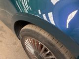 a close up of a car ' s tire on the street
