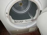 a white washer and dryer in a small room