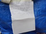 a blue bag with a piece of paper in it