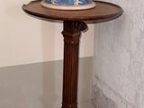 a blue and white vase sitting on a small table