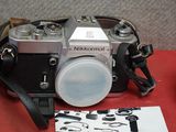 a black and silver camera on a red table