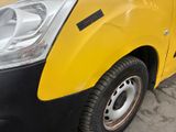 a yellow and black truck parked on the side of the road