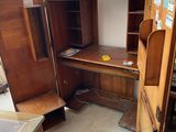 a wooden desk with a computer on it in a room