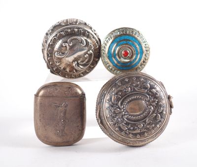 four antique silver and enamel buttons on display on a white surface