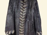 the back view of a fur coat with a long tail