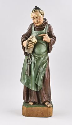 une statue représentant un moine tenant un livre à la main
