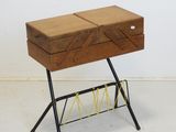 une petite table en bois sur laquelle se trouve un porte-revues
