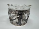 a glass cup with a silver decoration on it