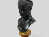a close up of a bust of a man on a wooden pedestal