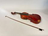 an old violin with a bow on a white surface