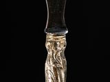 a glass vase with a statue on top of it