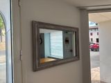 a mirror hanging on the wall in a room