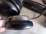 a person holding a pair of headphones that are on a table