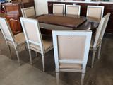 a table and chairs in a room with a lot of furniture