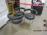 three chairs that are sitting on the floor in a warehouse