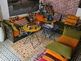 a living room with a lot of colorful pillows on the floor