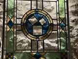 a stained glass window with a cross on it