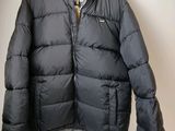 a close up of a jacket hanging on a hanger on a wall