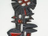 an image of a metal wall decoration with a red and black design
