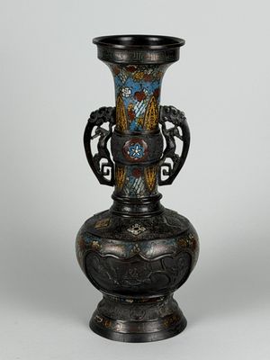 a vase that is sitting on a stand on a table
