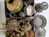 a box full of brass items on a white surface