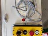 a yellow box with wires attached to it in a garage