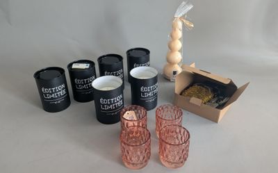 several glasses and a box of food on a table