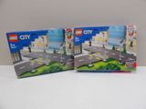 three lego city sets are sitting on a white table