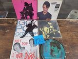 many cds and cds on a table with a blue tag