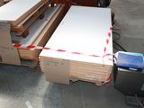 several pieces of wood are stacked on pallets in a warehouse