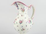a white vase with a floral design on it