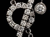 a silver necklace with a diamond pendant on it
