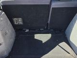 the back of a car with its trunk open and the seats folded down