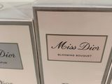 three boxes of perfume sitting on top of a white table